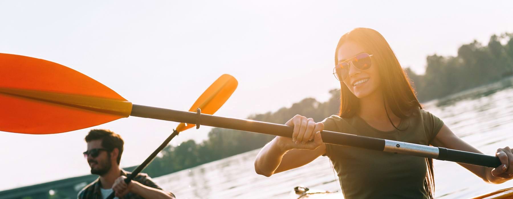 man and woman kayaking on lake